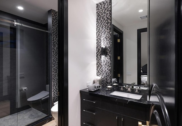 bathroom featuring walk in shower, hardwood / wood-style floors, vanity, and toilet