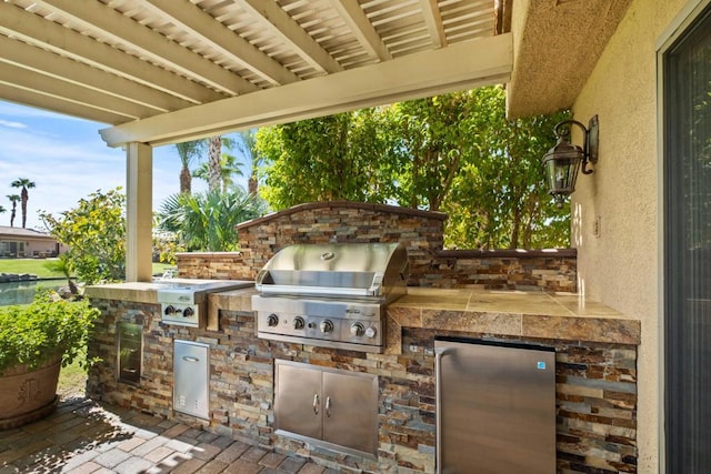 view of patio featuring exterior kitchen and grilling area