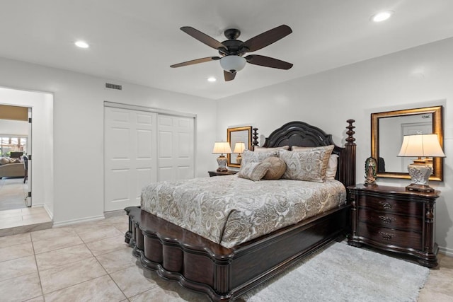 tiled bedroom featuring ceiling fan and a closet