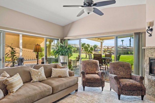 sunroom / solarium with ceiling fan, lofted ceiling, and a fireplace