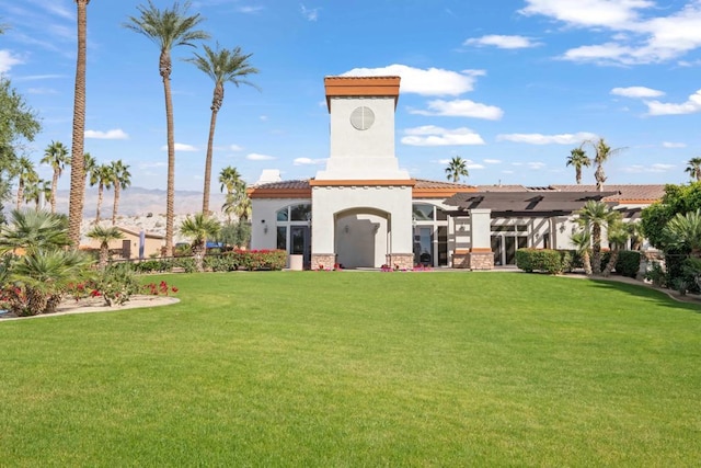 rear view of property featuring a lawn