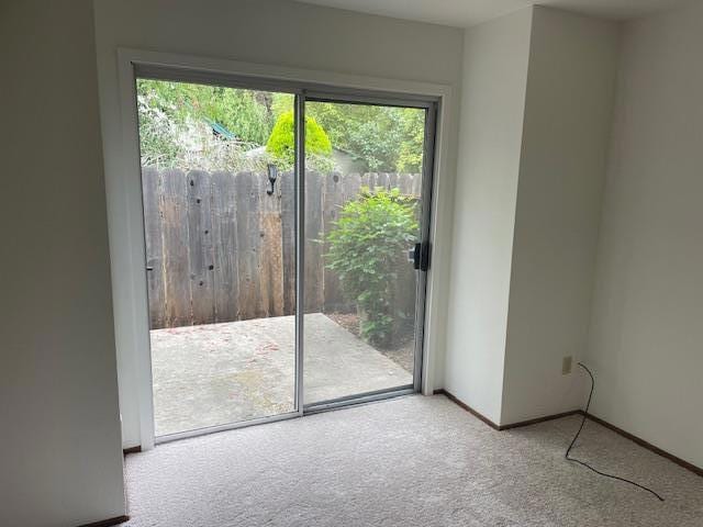 doorway featuring light carpet