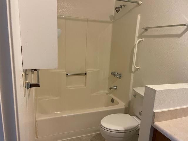 full bathroom featuring vanity, bathtub / shower combination, and toilet