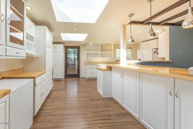 kitchen with a skylight and white cabinetry