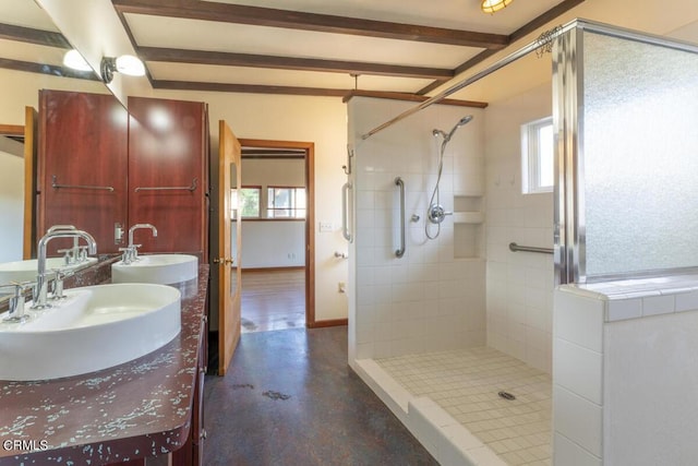 bathroom featuring plenty of natural light, a tile shower, and concrete floors