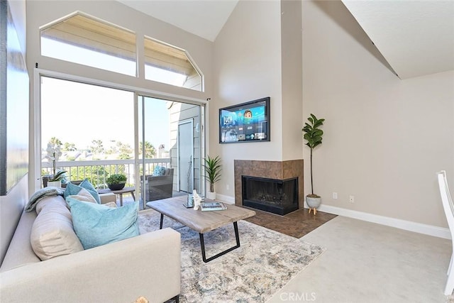 living room with high vaulted ceiling, plenty of natural light, and a tile fireplace