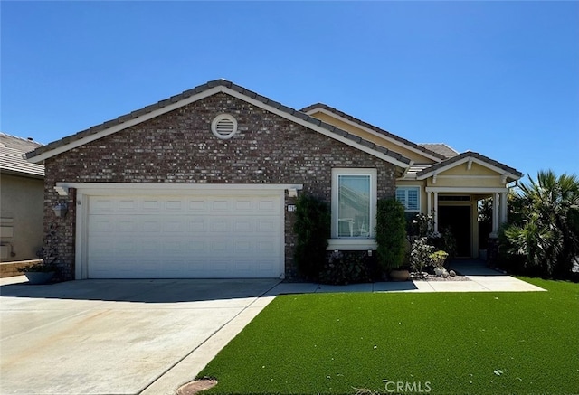 view of front of house featuring a garage and a front lawn