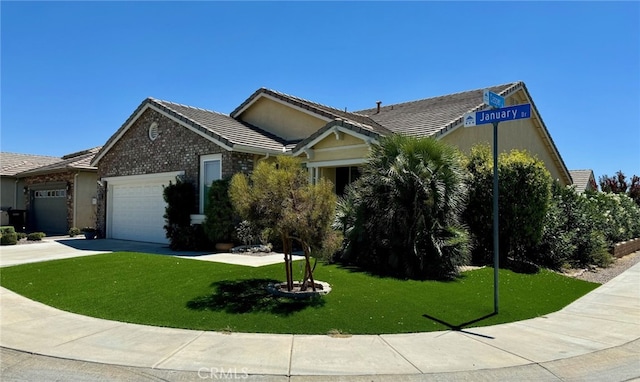 view of front of home with a front yard and a garage