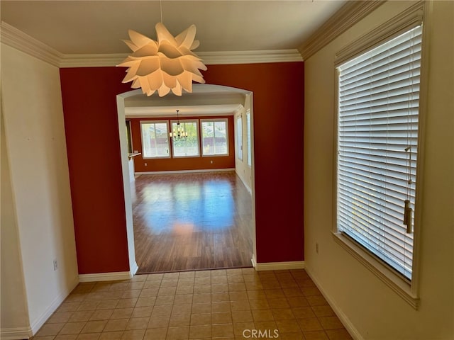 interior space featuring a notable chandelier, hardwood / wood-style floors, and crown molding