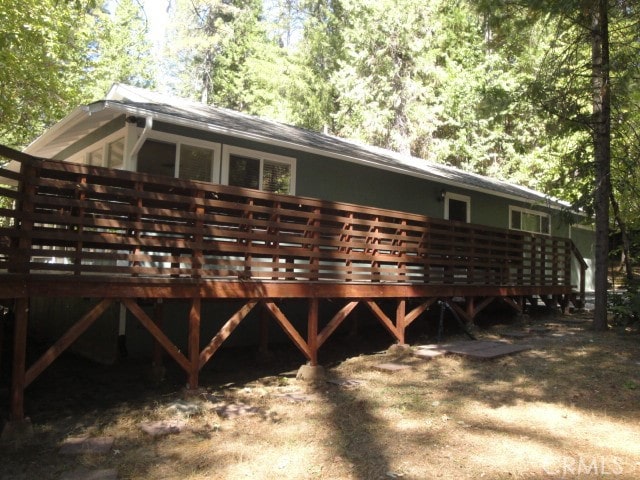 back of house with a wooden deck