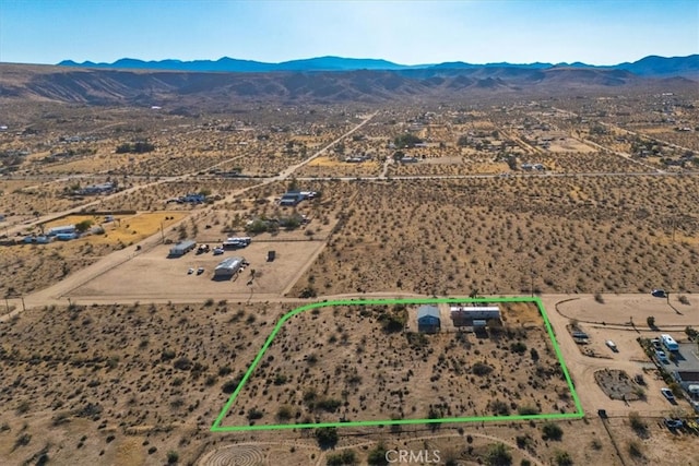 birds eye view of property with a mountain view