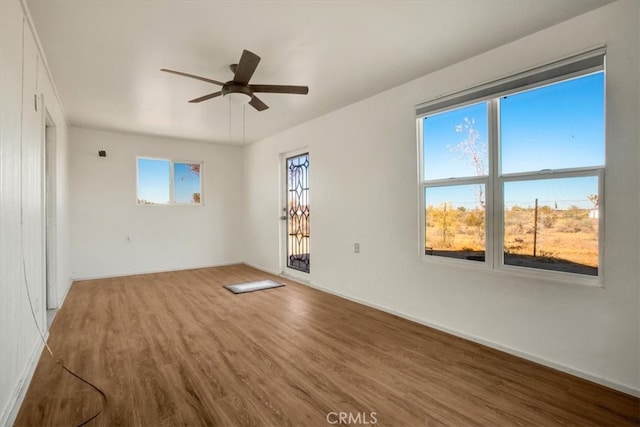 spare room featuring ceiling fan and hardwood / wood-style floors