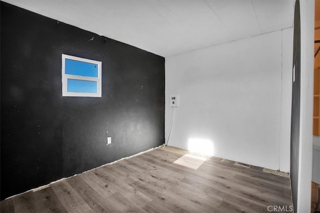 unfurnished room featuring wood-type flooring