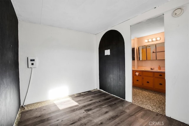 empty room with hardwood / wood-style floors and sink