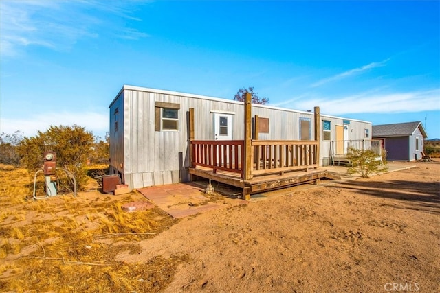 rear view of house featuring a deck