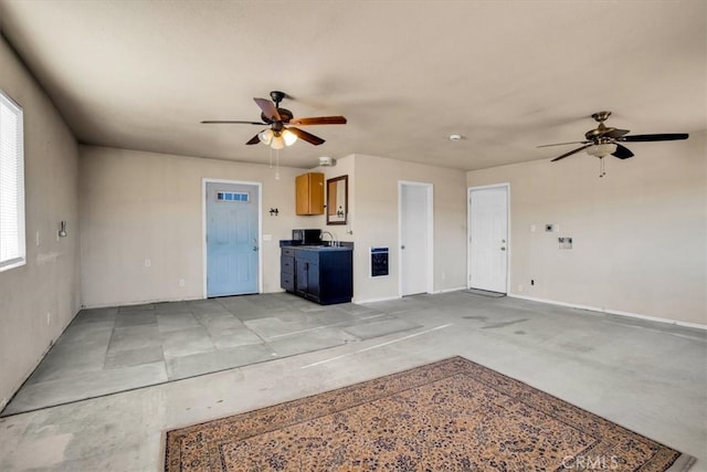 interior space with ceiling fan and sink