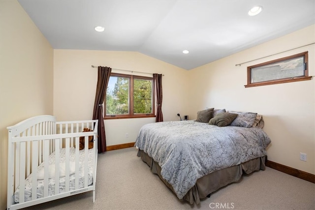 bedroom with lofted ceiling and light colored carpet