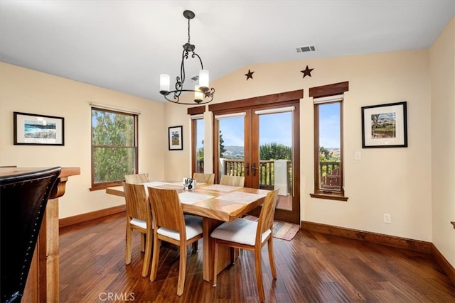 dining area with an inviting chandelier, vaulted ceiling, french doors, and dark hardwood / wood-style flooring