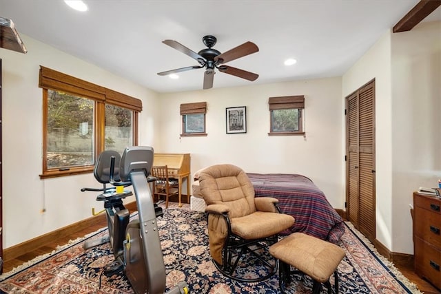 bedroom featuring hardwood / wood-style floors, a closet, and ceiling fan