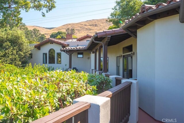 view of side of home with a mountain view