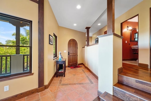 hall featuring light tile patterned flooring and a wealth of natural light