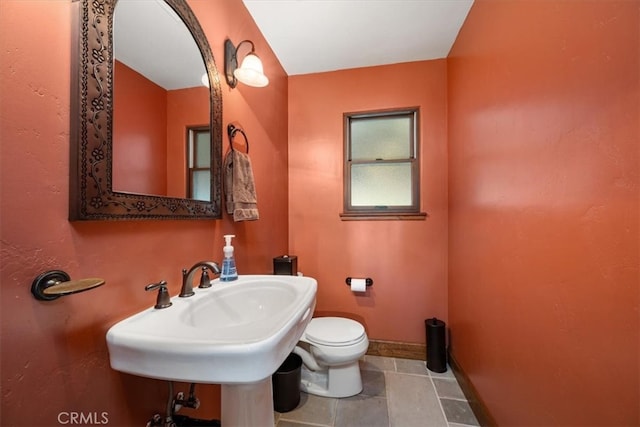 bathroom featuring tile patterned flooring and toilet