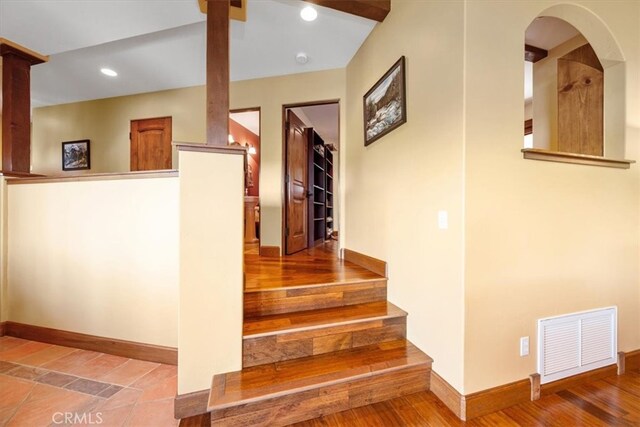 stairway with hardwood / wood-style floors