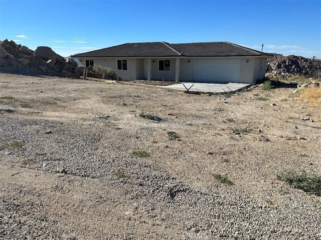 rear view of house with a garage