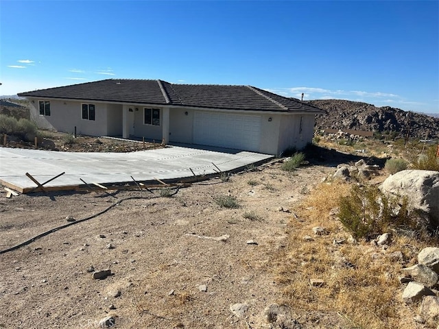 view of front of property with a mountain view and a garage