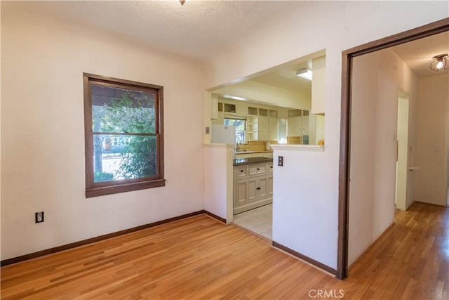 kitchen featuring white cabinetry and light hardwood / wood-style floors