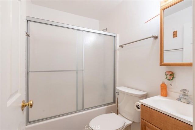 full bathroom with vanity, toilet, and combined bath / shower with glass door