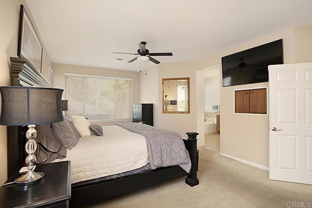 bedroom featuring ensuite bath, ceiling fan, and light carpet