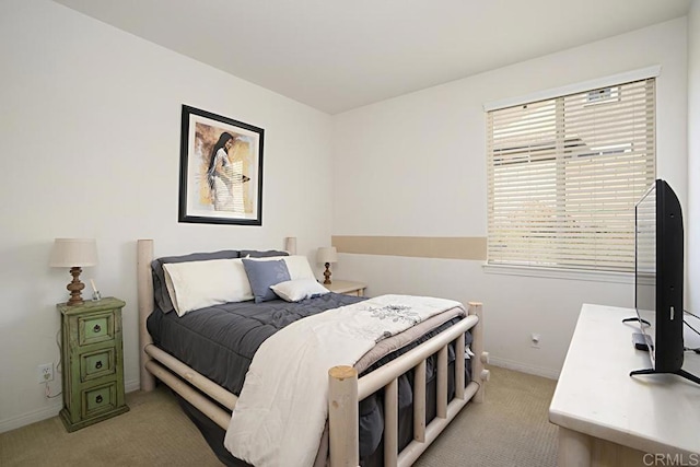 bedroom featuring baseboards and light colored carpet