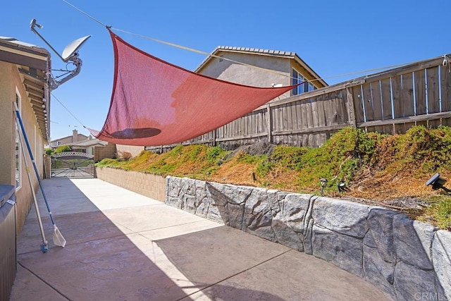 view of patio featuring a gate and fence