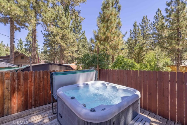 wooden terrace featuring a hot tub