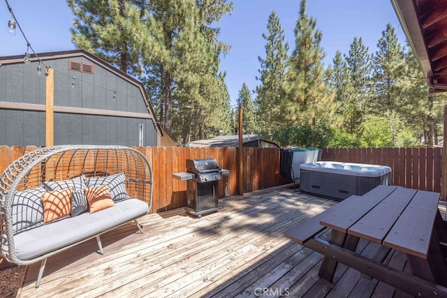 wooden terrace with a grill and a hot tub