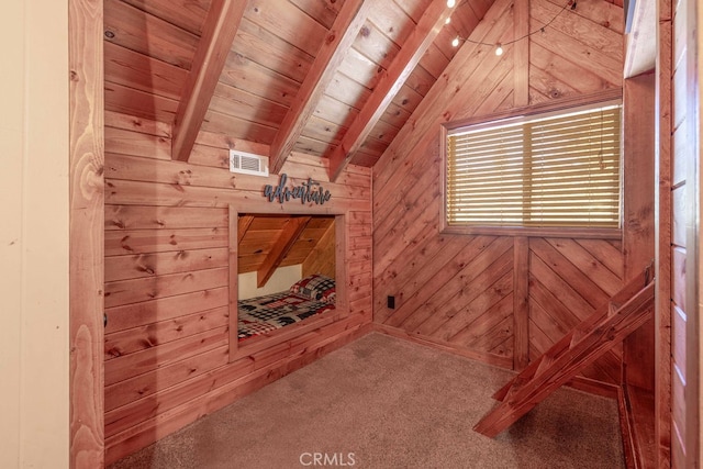 unfurnished room featuring vaulted ceiling with beams, wooden walls, carpet flooring, and wooden ceiling