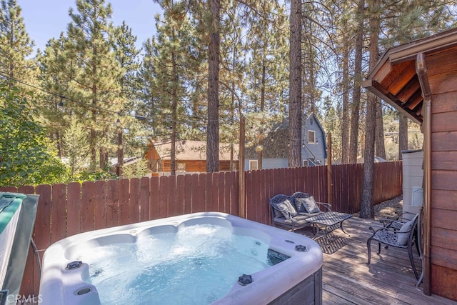 wooden terrace with a hot tub