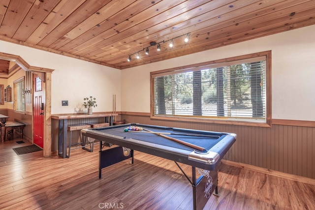 game room featuring wood-type flooring, bar, and wooden ceiling