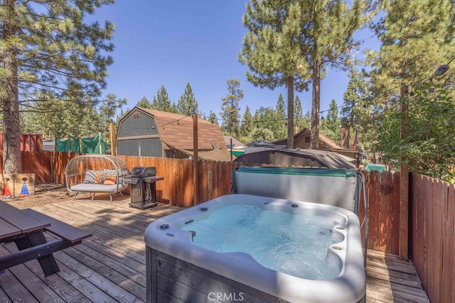 wooden terrace with a hot tub