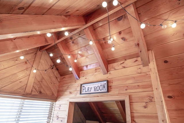 interior details featuring beamed ceiling, wood ceiling, and wood walls