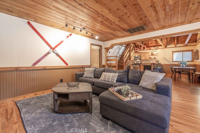 living room with wood ceiling, wood walls, and hardwood / wood-style floors