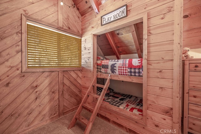 unfurnished bedroom featuring wooden ceiling, carpet, wood walls, and beamed ceiling