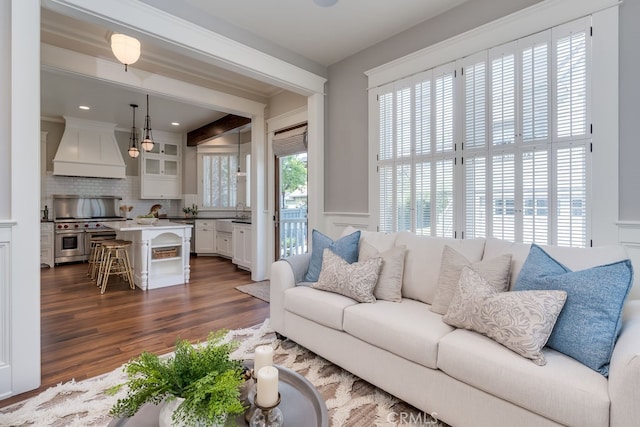 living room featuring ornamental molding and dark hardwood / wood-style flooring