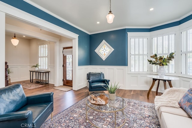 living room with hardwood / wood-style flooring and ornamental molding