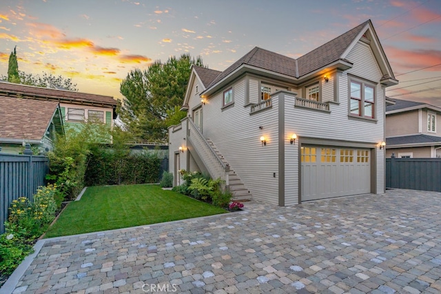 view of front of house featuring a yard and a garage