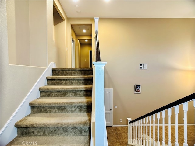 stairs featuring tile patterned flooring