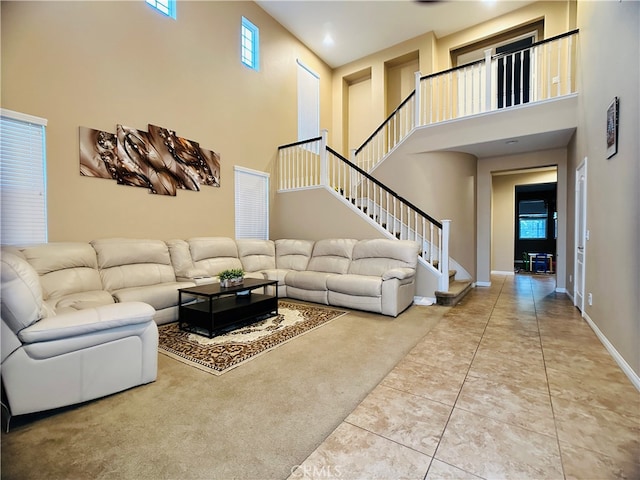 living room featuring tile patterned floors, a high ceiling, and a wealth of natural light