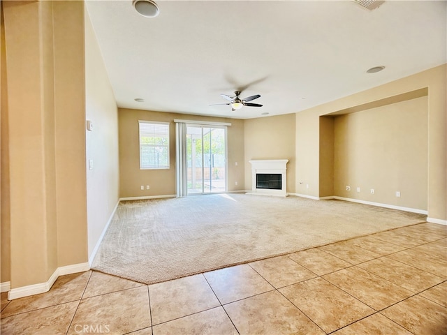 unfurnished living room with ceiling fan and light colored carpet