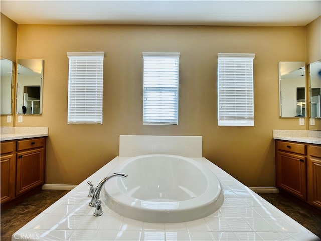 bathroom featuring vanity and a bath